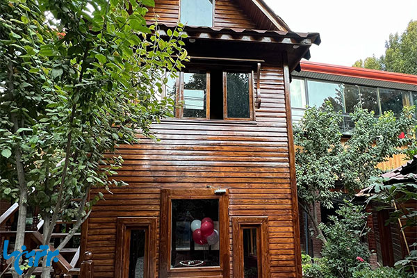 باغ رستوران بهشاد، با کلبه‌های چوبی در تهران